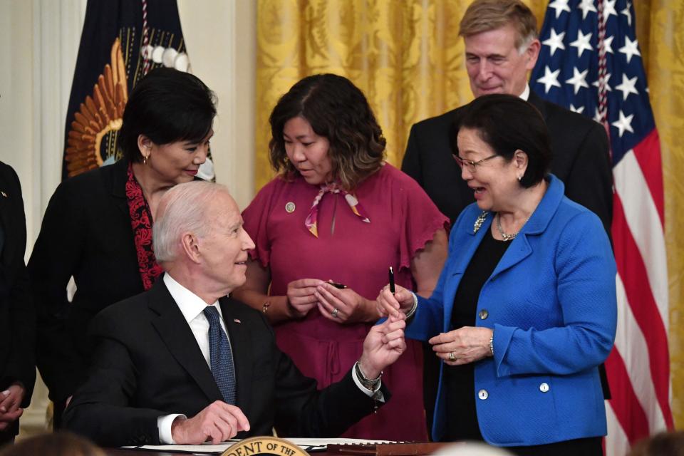 President Joe Biden hands over a pen to Sen. Mazie Hirono, D-Hawaii,  after signing the Covid-19 Hate Crimes Act, in the East Room of the White House in Washington, D.C., on May 20, 2021.