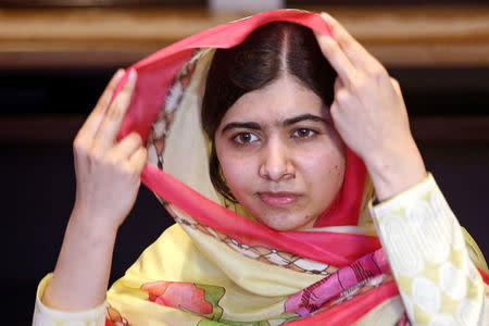 Nobel Peace Prize laureate Malala Yousafzai adjusts her scarf as she speaks during an interview with Reuters at a local hotel in Islamabad, Pakistan, March 30, 2018. REUTERS/Saiyna Bashir