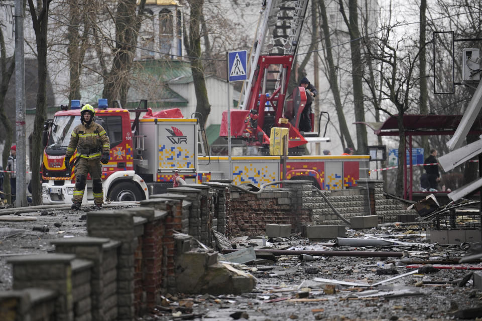 A firefighter walks amongst the debris after a Russian attack in Kyiv, Ukraine, Thursday, March 21, 2024. Around 30 cruise and ballistic missiles were shot down over Kyiv on Thursday morning, said Serhii Popko, the head of Kyiv City Administration. The missiles were entering Kyiv simultaneously from various directions in a first missile attack on the capital in 44 days. (AP Photo/Vadim Ghirda)