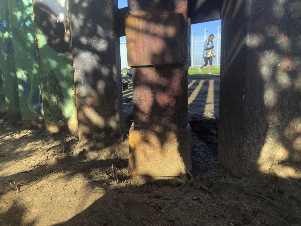 Smugglers allegedly cut a roughly 18-inch (1.2-meter) opening in the steel-pole of a border wall, since repaired, a breach that the U.S. Border Patrol said led to the "unintentional destruction" of a cross-border garden earlier this month in Friendship Park, located within California's Border Field State Park, in San Diego, Saturday, Jan. 25, 2020. The U.S. Border Patrol gave activists no warning this month after the breach believed to be by smugglers when it bulldozed the U.S. side of the cross-border garden which overlooks the Pacific Ocean. On Saturday, after a public apology for "the unintentional destruction," the agency allowed the activists in a highly restricted area to resurrect the garden. (AP Photo/Elliot Spagat)