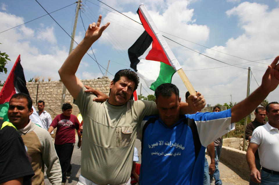 This undated publicity photo released by Kino Lorber, Inc. shows Adeeb and Phil participating in a protest against the Israeli settlements in a scene from the documentary film, "5 Broken Cameras," co-directed by Emad Burnat and Guy Davidi. (AP Photo/Kino Lorber, Inc.)