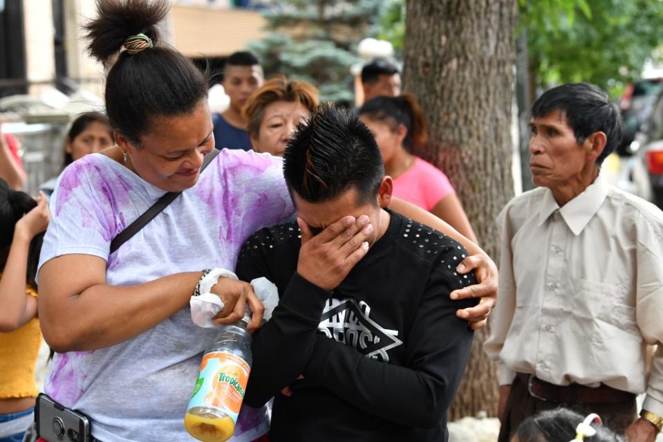 Mourners cry after the child’s death. Paul MARTINKA 718.810.5185