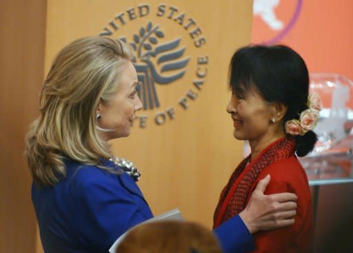 US Secretary of State of Hillary Clinton speaks to Myanmar member of parliament and democracy icon Aung San Suu Kyi after introducing her at the United States Institute of Peace September 18