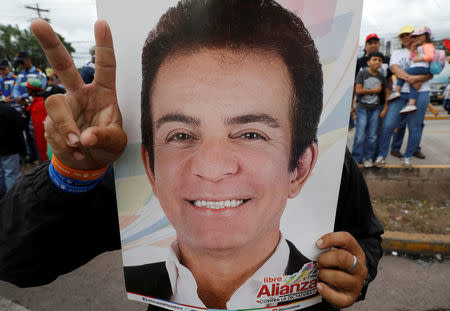 A supporter holds up a poster of Salvador Nasralla, presidential candidate for the Opposition Alliance Against the Dictatorship as he takes part in a protest while the country is still mired in chaos over a contested presidential election in Tegucigalpa, Honduras December 3, 2017. REUTERS/Henry Romero