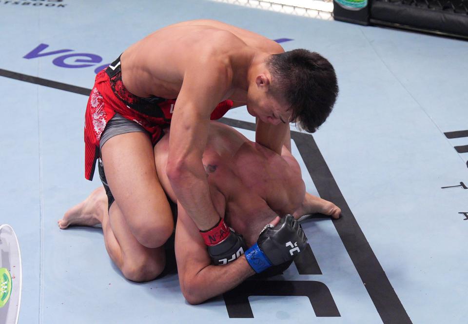 LAS VEGAS, NEVADA – AUGUST 10: (L-R) Toshiomi Kazama of Japan punches Charalampos Grigoriou of Cyprus in a bantamweight fight during the UFC Fight Night event at UFC APEX on August 10, 2024 in Las Vegas, Nevada . (Photo by Al Powers/Zuffa LLC)