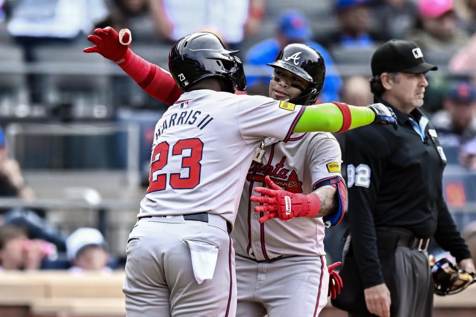 May 11, 2024; New York City, New York, USA; Atlanta Braves shortstop Orlando Arcia (11) is greeted at hom plate by Atlanta Braves outfielder Michael Harris II (23) after hitting a two run home run against the New York Mets during the third inning on May 11, 2024, at Citi Field.
