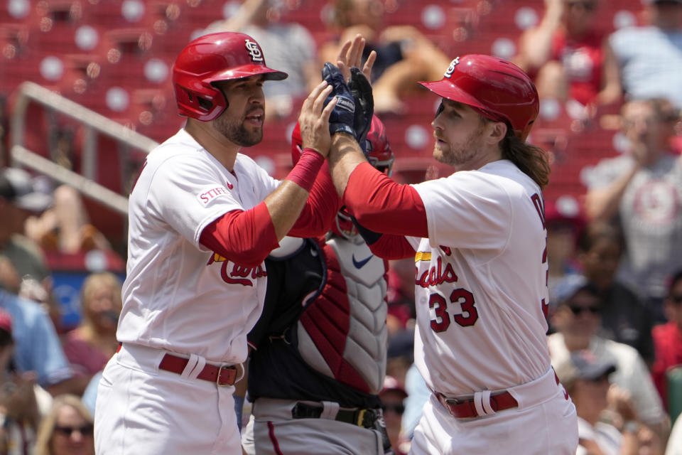 St. Louis Cardinals' Brendan Donovan (33) is congratulated by teammate Dylan Carlson after hitting a three-run home run during the fifth inning in the first game of a baseball doubleheader against the Washington Nationals Saturday, July 15, 2023, in St. Louis. The contest was the resumption of a game started on Friday, but was suspended due to rain. (AP Photo/Jeff Roberson)