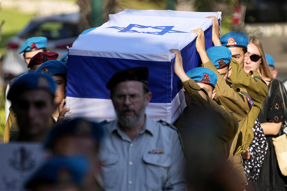 Israeli soldiers carry the flag-covered coffin of Staff Sgt. Maksym Molchanov during his funeral in Kiryat Shaul military cemetery in Tel Aviv, Israel, Tuesday, Sept. 5, 2023. In an alleged attack, a Palestinian driver rammed his truck into pedestrians at a checkpoint in the occupied West Bank last Thursday, killing Molchanov and injuring three other Israeli troops before being shot and killed. (AP Photo/Ariel Schalit)