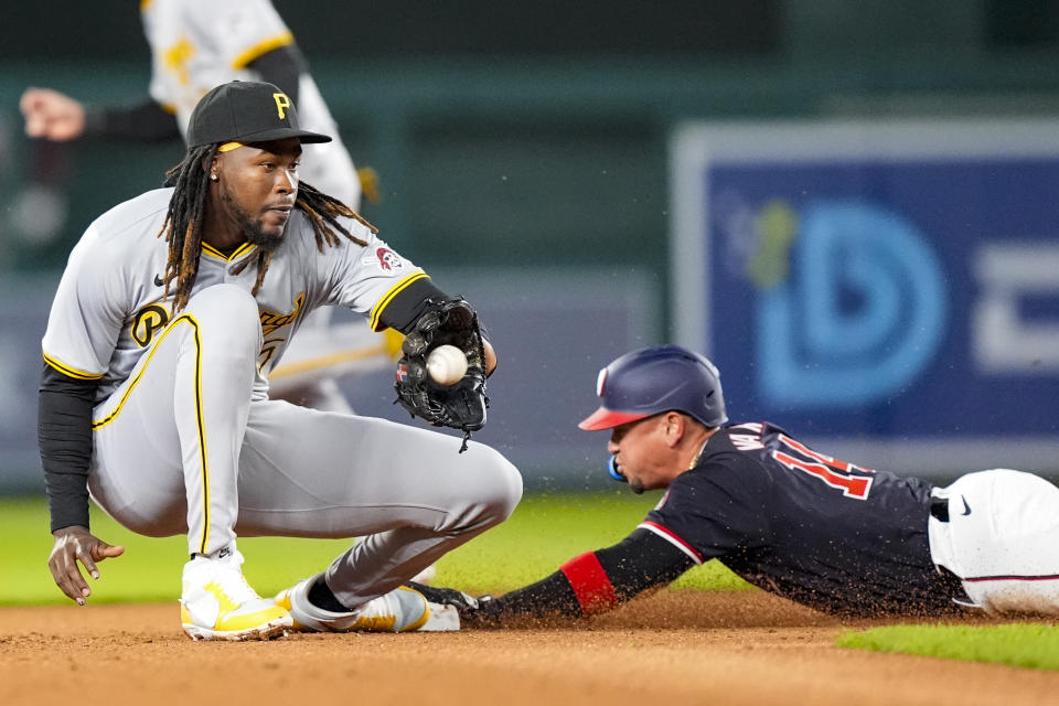 Washington Nationals' Ildemaro Vargas steals second base as Pittsburgh Pirates shortstop Oneil Cruz waits for the throw during the fourth inning of a baseball game at Nationals Park, Wednesday, April 3, 2024, in Washington. (AP Photo/Alex Brandon)