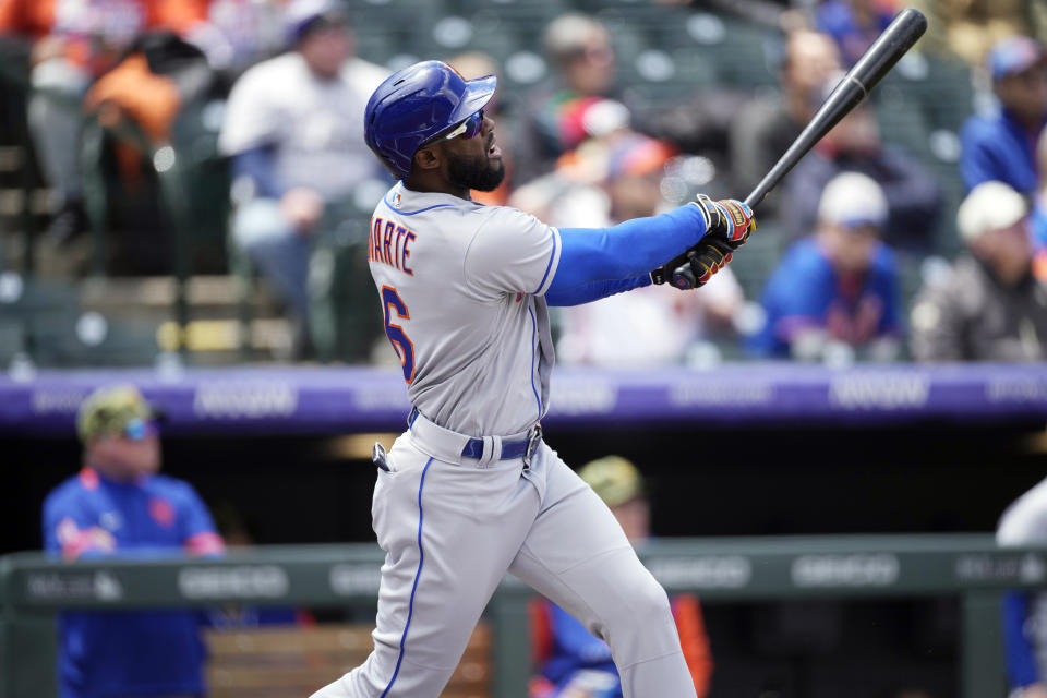 New York Mets' Starling Marte follows the flight of his two-run home run off Colorado Rockies starting pitcher German Marquez in the first inning during the first baseball game of a doubleheader, Saturday, May 21 2022, in Denver. (AP Photo/David Zalubowski)