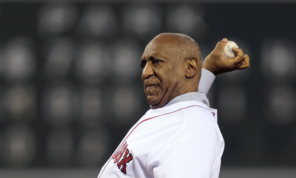 Comedian Bill Cosby delivers a ceremonial first pitch prior to a baseball game between the New York Yankees and the Boston Red Sox, Thursday, Sept. 13, 2012, at Fenway Park in Boston. (AP Photo/Charles Krupa)