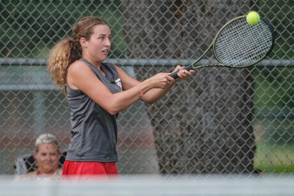 Dover's Josie Pinelli returns a serve during their match against Marietta, Tuesday, Aug. 9 at Dover City Park.