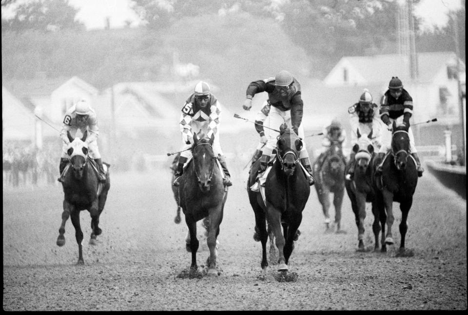 Jockey Angel Cordero Jr. reacts at the finish line after guiding Bold Forbes to victory in the 1976 Kentucky Derby.