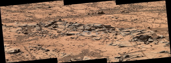 A small ridge on Mars, about 3 feet (1 meter) in length, appears to resist wind erosion more than the flatter plates around it. Curiosity rover's Mast Camera (Mastcam) obtained the exposures in this mosaic on Oct. 7, 2014.