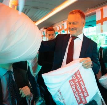 Steve Reed hands out pillows (PA)