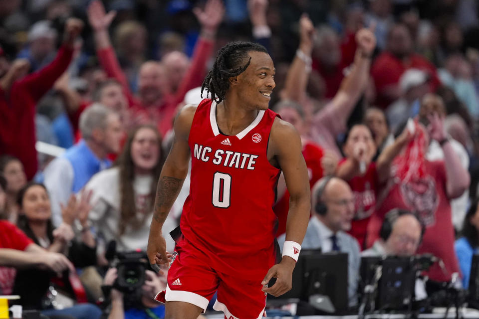 North Carolina State guard DJ Horne (0) celebrates his three-pointer against North Carolina during the second half of an NCAA college basketball game in the championship of the Atlantic Coast Conference tournament, Saturday, March 16, 2024, in Washington. (AP Photo/Alex Brandon)