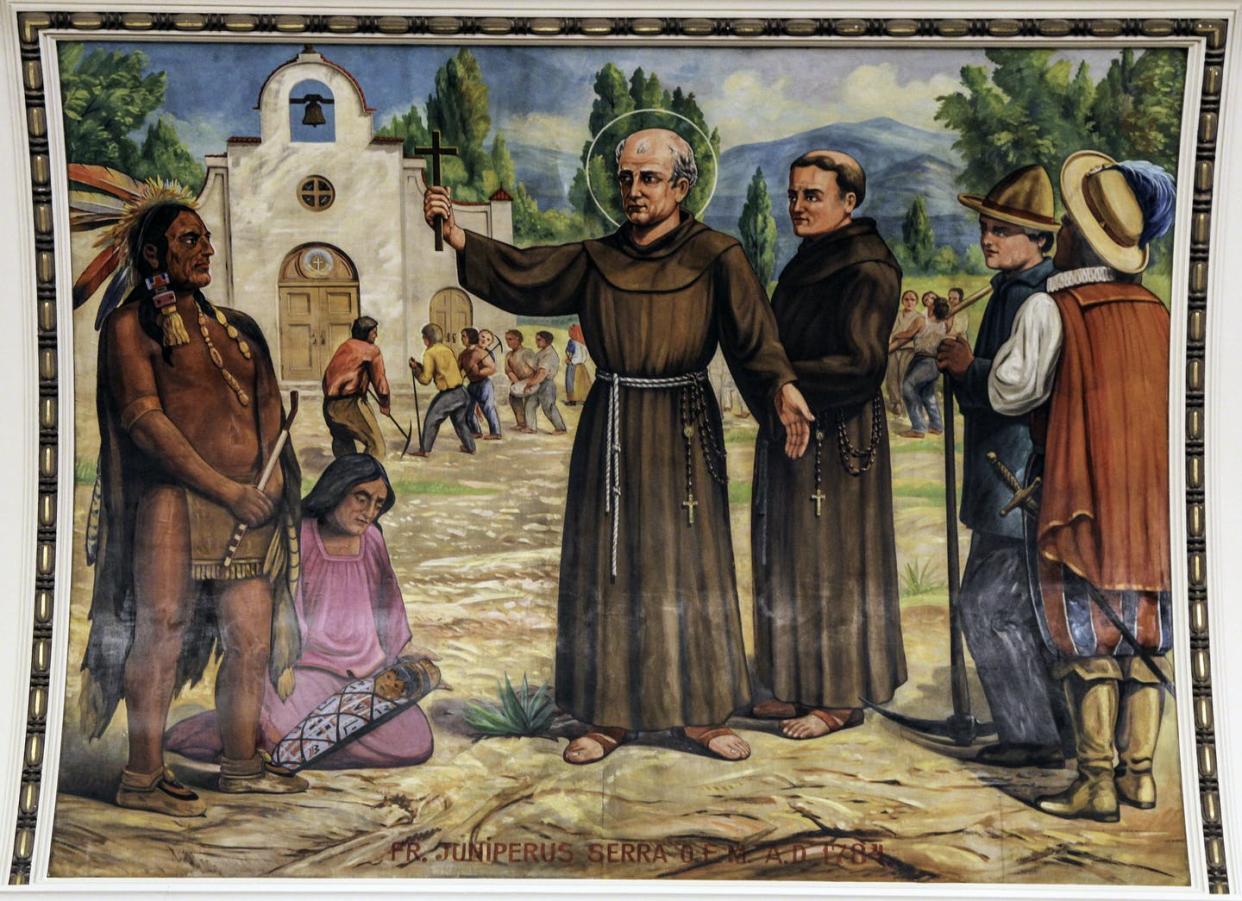 <span class="caption">The 18th-century Catholic missionary Junipero Serra at work in California. </span> <span class="attribution"><span class="source">Lawrence OP/flickr/St. Casimir’s church in Baltimore</span>, <a class="link " href="http://creativecommons.org/licenses/by-sa/4.0/" rel="nofollow noopener" target="_blank" data-ylk="slk:CC BY-SA;elm:context_link;itc:0;sec:content-canvas">CC BY-SA</a></span>