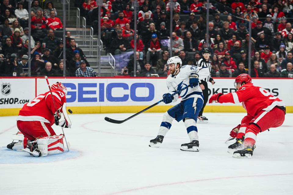 Tampa Bay Lightning center Brayden Point (21) scores a goal on Detroit Red Wings goaltender Ville Husso (35) as defenseman Jake Walman (96) defends during the first period at Little Caesars Arena in Detroit on Saturday, Feb. 25, 2023.