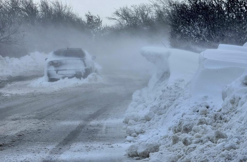 A car is left on the road near town of Dobrich, Bulgaria, Sunday, Nov. 19 2023. Gale-force winds and heavy rain and snow hit large parts of Bulgaria claiming the lives of two people and causing severe damages and disrupting power supply in towns and villages, officials said on Sunday. (Bulgarian News Agency via AP)