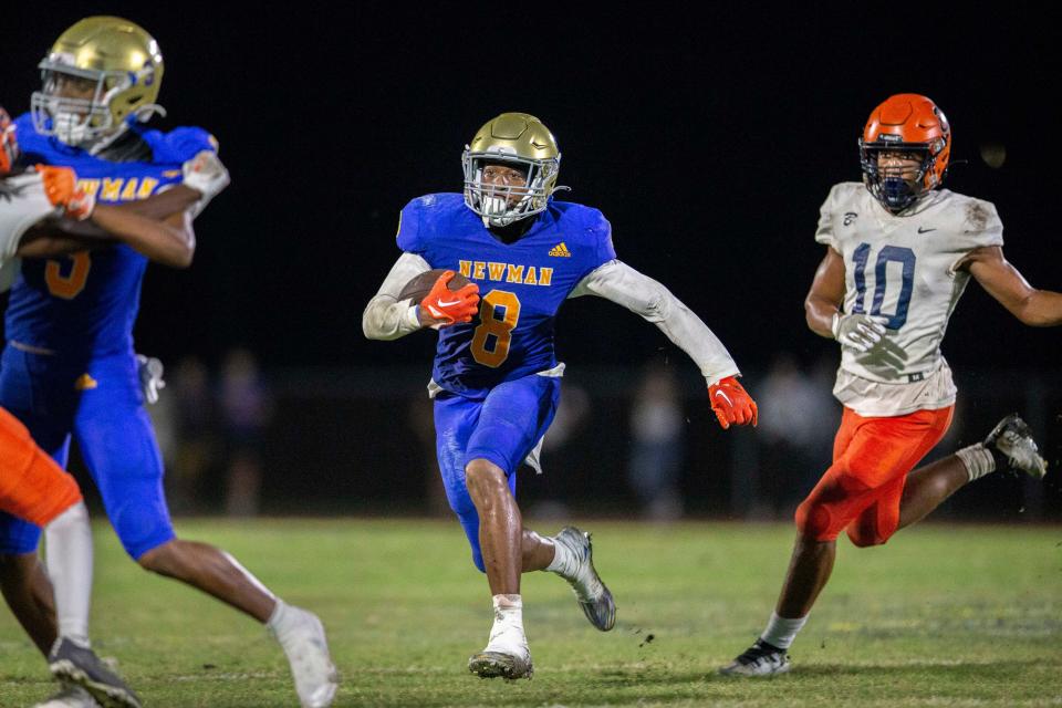 Cardinal Newman running back Xanai Scott runs the ball against Benjamin during the regional semifinal playoff football game in West Palm Beach on November 17, 2023.