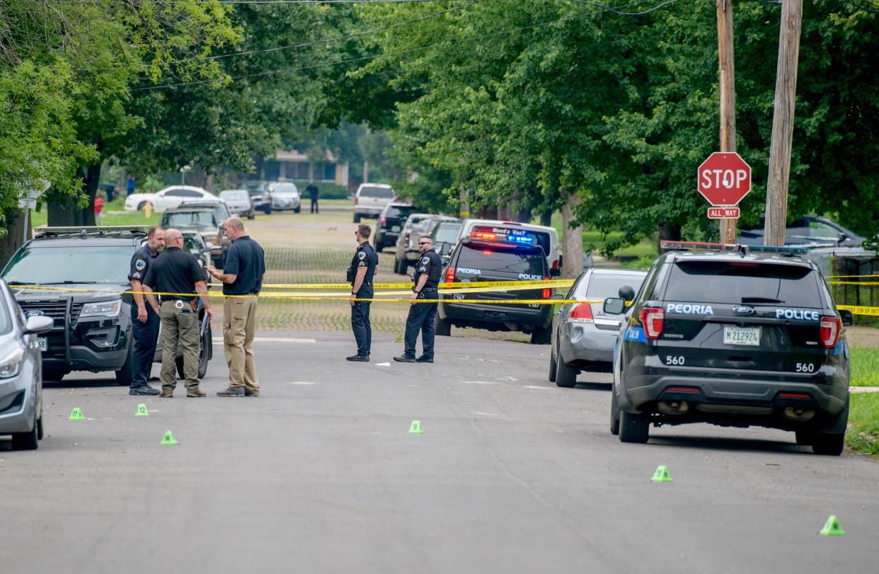 Evidence markers dot the street on North Central Avenue between East Republic Street and East Frye Avenue as Peoria police officers work the scene of a shooting Saturday, July 16, 2022, in Peoria.