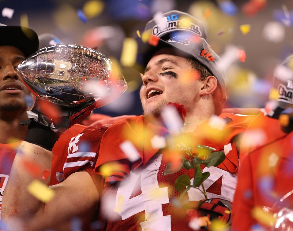 INDIANAPOLIS, IN - DECEMBER 01: Chris Borland #44 of the Wisconsin Badgers celebrates the Big Ten Championship holding the Amos Alonzo Stagg Championship Trophy after defeating the Nebraska Cornhuskers 70-31 at Lucas Oil Stadium on December 1, 2012 in Indianapolis, Indiana. (Photo by Leon Halip/Getty Images)