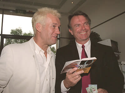 Oh Barnesy! Rocking the bleached hair and cream suit, Jimmy Barnes discusses which horse to back with Sam Neill at the Spring Carnival in 1998.