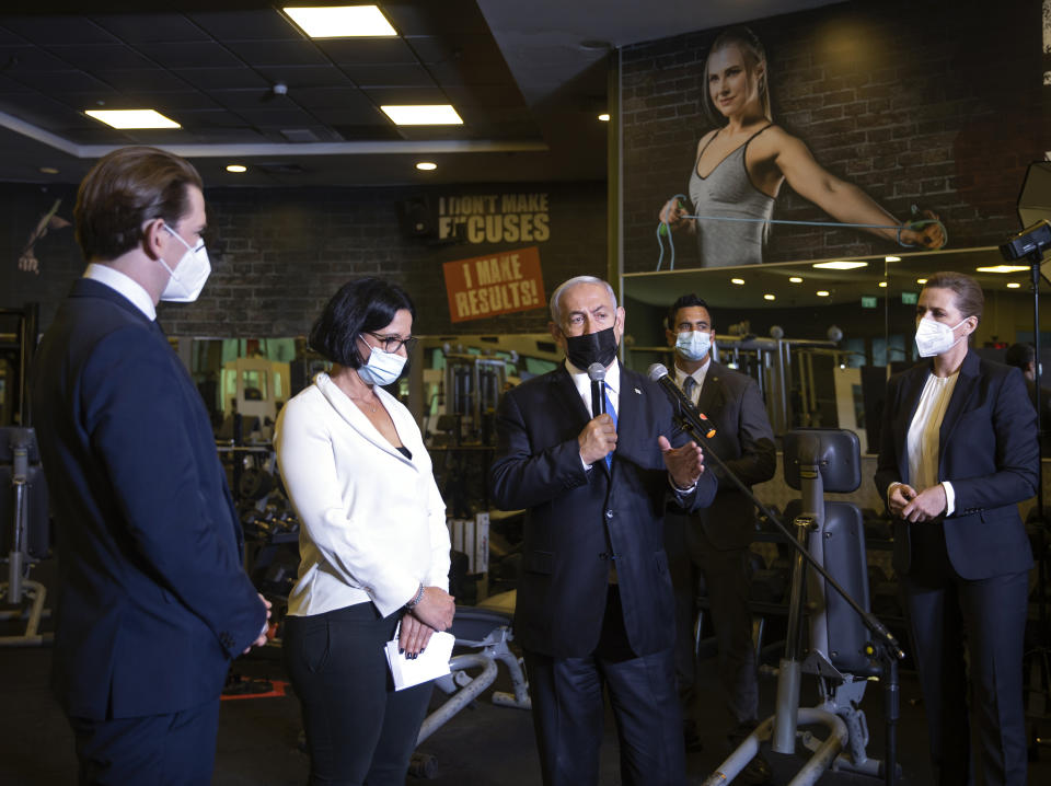 Israeli Prime Minister Benjamin Netanyahu, center, visits a fitness gym with Austrian Chancellor Sebastian Kurz, left, and Danish Prime Minister Mette Frederiksen, right, to observe how the "Green Pass," for citizens vaccinated against COVID-19, is used, in Modi'in, Israel, Thursday, March 4, 2021. Frederiksen and Kurz are on a short visit to Israel for to pursue the possibilities for closer cooperation on COVID-19 and vaccines. (Avigail Uzi/Pool via AP)