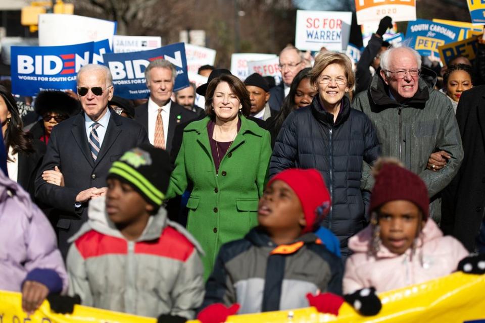 Democratic presidential candidates (left to right) Joe Biden, Amy Klobuchar, Elizabeth Warren, and Bernie Sanders march together for Martin Luther King Jr. Day in Columbia, South Carolina on Monday | Sean Rayford/Getty