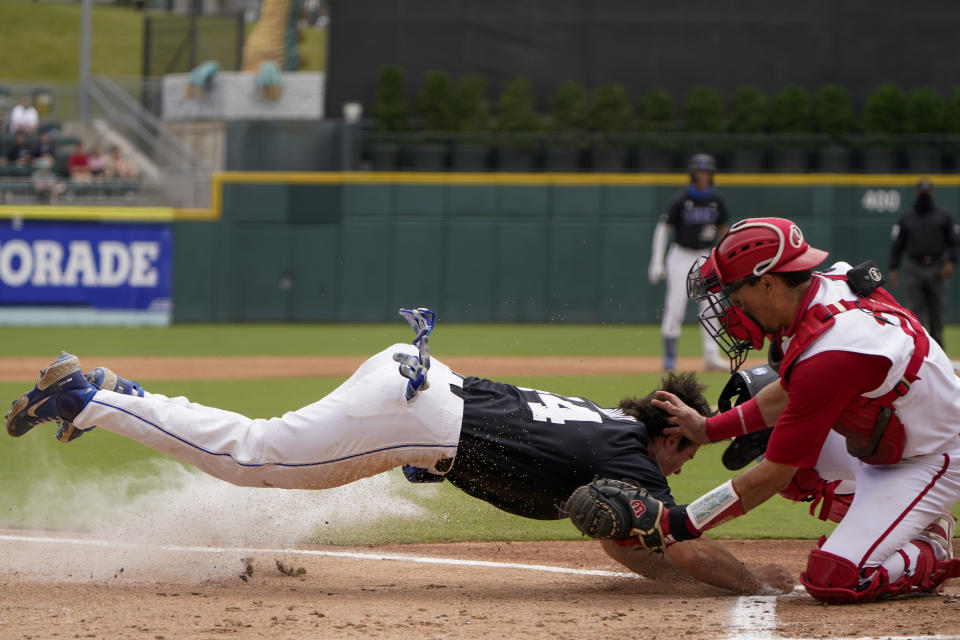 Duke's Graham Pauley, left, is tagged out at home by North Carolina State catcher Luca Tresh trying to score on a double by Joey Loperfido in the third inning of an NCAA college baseball game at the Atlantic Coast Conference championship game on Sunday, May 30, 2021, in Charlotte, N.C. (AP Photo/Chris Carlson)