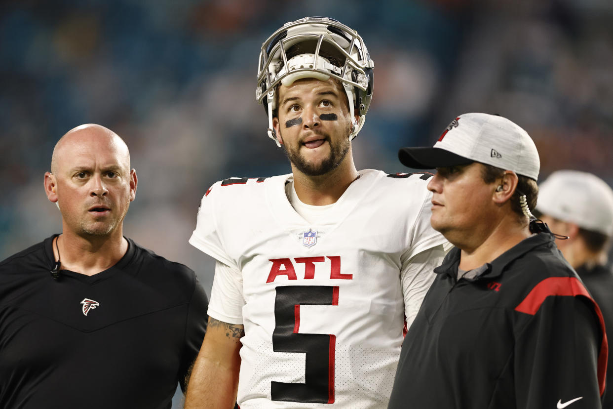 MIAMI GARDENS, FLORIDA - AUGUST 21: AJ McCarron #5 of the Atlanta Falcons reacts as he is helped off the field by trainers after being injured during a preseason game against the Miami Dolphins at Hard Rock Stadium on August 21, 2021 in Miami Gardens, Florida. (Photo by Michael Reaves/Getty Images)