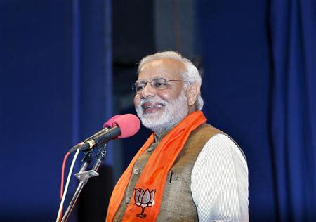 Hindu nationalist Narendra Modi, who will be the next prime minister of India, smiles as he addresses Gujarat state lawmakers and party workers during the appointment of the state's new chief minister in Gandhinagar May 21, 2014. REUTERS/Amit Dave