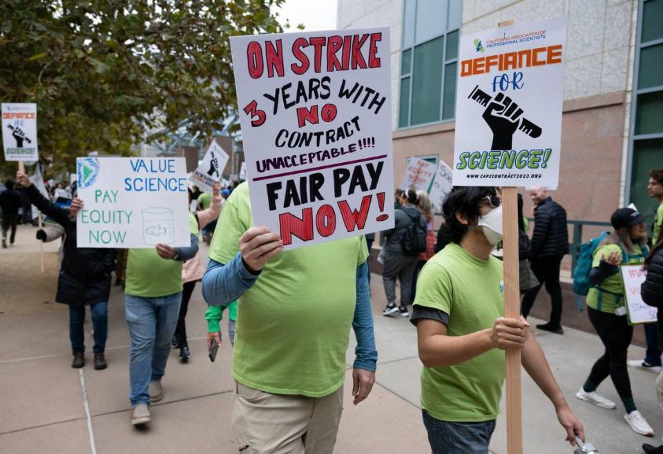 “3 years with no contract,” reads a sign held by a striking member of the California Association of Professional Scientists during the first strike by California civil servants at Cal EPA Building in Sacramento on Wednesday. The strike is planned for three days.