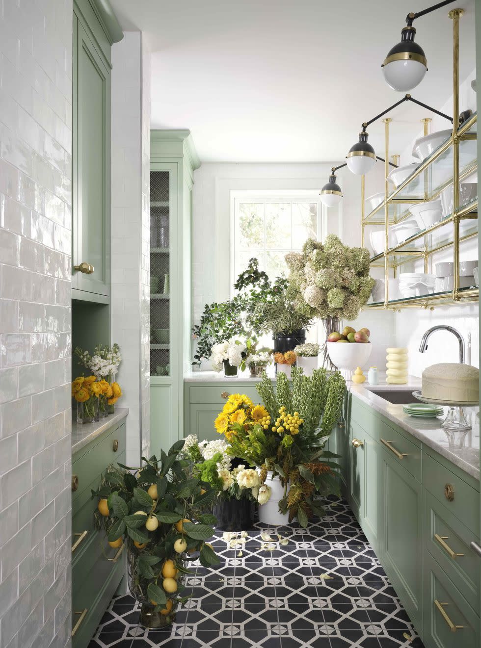 a green butlers pantry with a sink and flowers