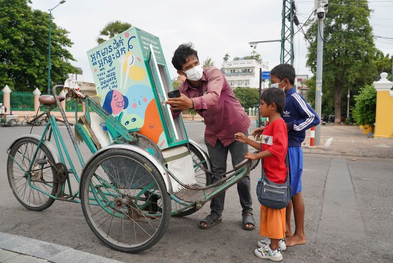 Cambodian cyclo-drivers pedal mobile food banks to deliver aid