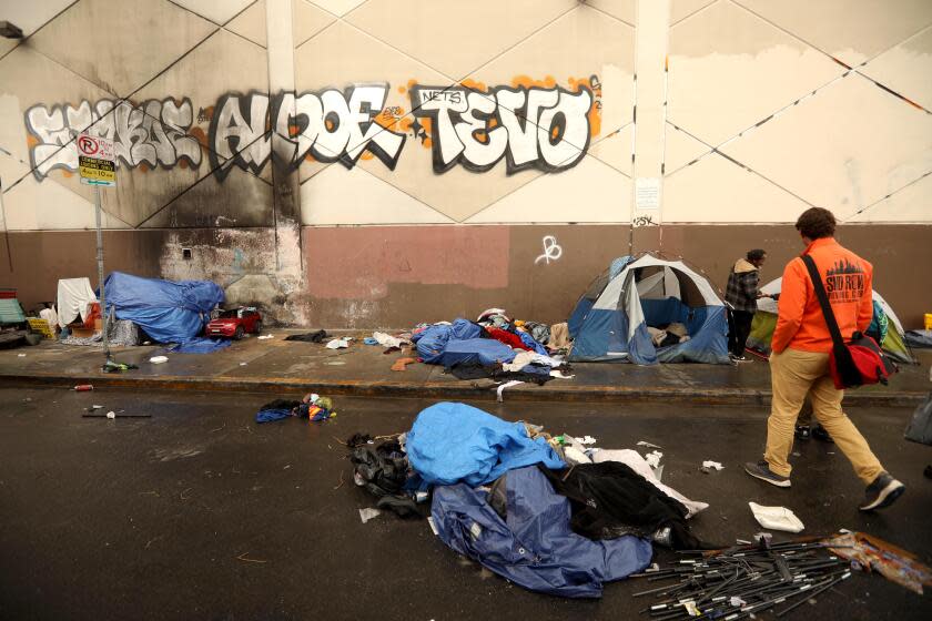 LOS ANGELES, CA - JANUARY 25, 2024 - - Dr. Steven Hochman, right, with AKIDO Care, prepares to check on the wellbeing of a homeless man while working with outreach workers with SUDIS in Skid Row in downtown Los Angeles on January 25, 2024. (Genaro Molina/Los Angeles Times)