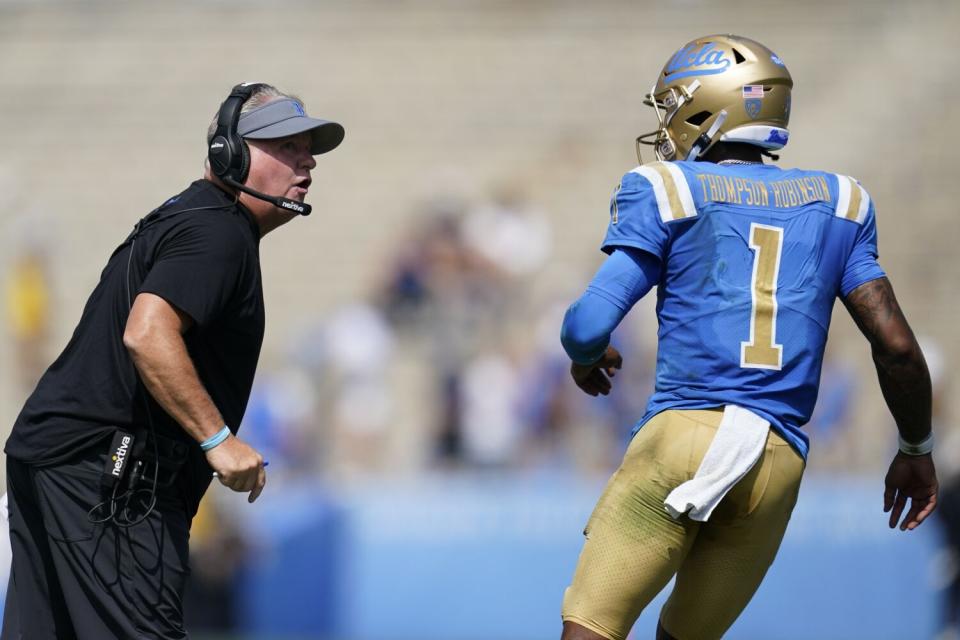 UCLA coach Chip Kelly talks to UCLA quarterback Dorian Thompson-Robinson.