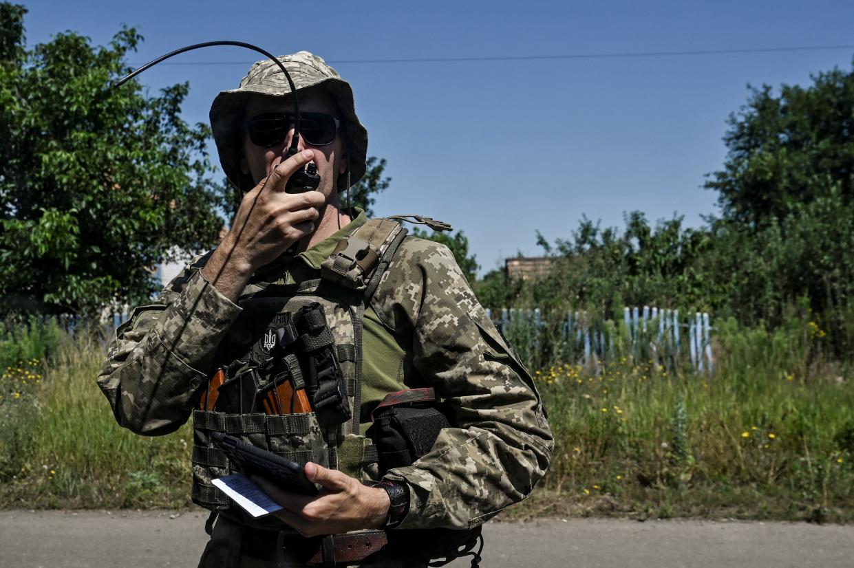 A Ukrainian serviceman speaks on a mobile radio near a front line, amid Russia's attack on Ukraine (REUTERS)