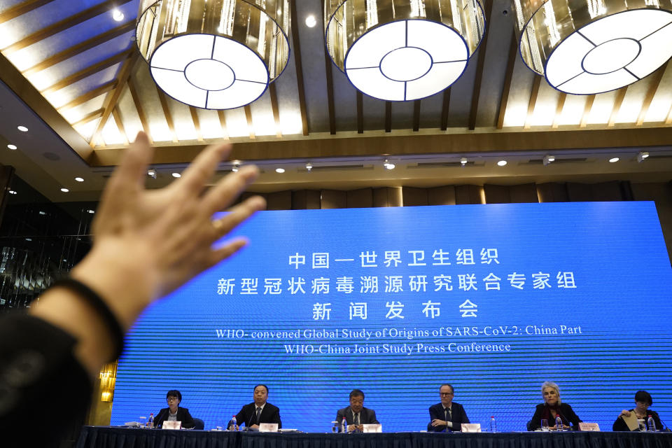 FILE - In this Feb. 9, 2021, file photo, journalist raises her hand to ask a question at the WHO-China Joint Study Press Conference held at the end of the World Health Organization mission in Wuhan, China. As the World Health Organization draws up plans for the next phase of its probe of how the coronavirus pandemic started, an increasing number of scientists say the U.N. agency it isn’t up to the task and shouldn’t be the one to investigate. Numerous experts, some with strong ties to WHO, say that political tensions between the U.S. and China make it impossible for an investigation by the agency to find credible answers. (AP Photo/Ng Han Guan, File)