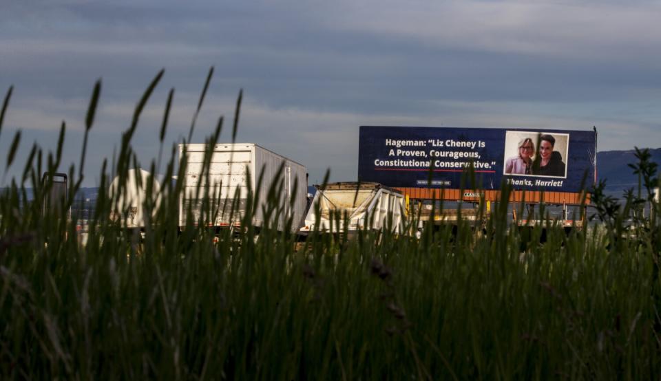 A billboard shows Harriet Hageman's support for Liz Cheney