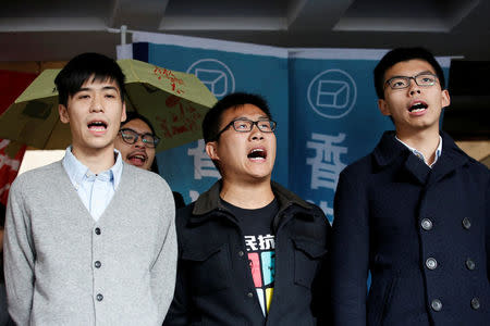 Pro-democracy activists (L-R) Lester Shum, Raphael Wong and Joshua Wong chant slogans outside High Court before receiving their sentences in Hong Kong, China January 17, 2018. REUTERS/Bobby Yip