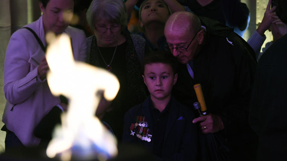 Eight year-old Henry Case and his grandfather Michael Case attend Anzac Day commemorations in Brisbane, Wednesday, April 25, 2018. Source: AAP