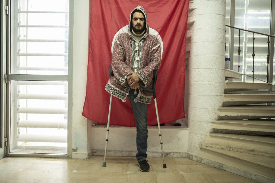 Wael Karrafi, 30, a protester who lost a leg after getting shot during Tunisia's democratic uprising 10 years ago poses for a portrait in Tunis, Tunisia, Tuesday, Jan. 12, 2021. (AP Photo/Mosa'ab Elshamy)