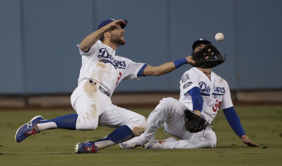 Los Angeles Dodgers' Chris Taylor makes a diving catch of a ball hit by Milwaukee Brewers' Orlando Arcia during the seventh inning of Game 4 of the National League Championship Series baseball game Tuesday, Oct. 16, 2018, in Los Angeles. (AP Photo/Jae Hong)