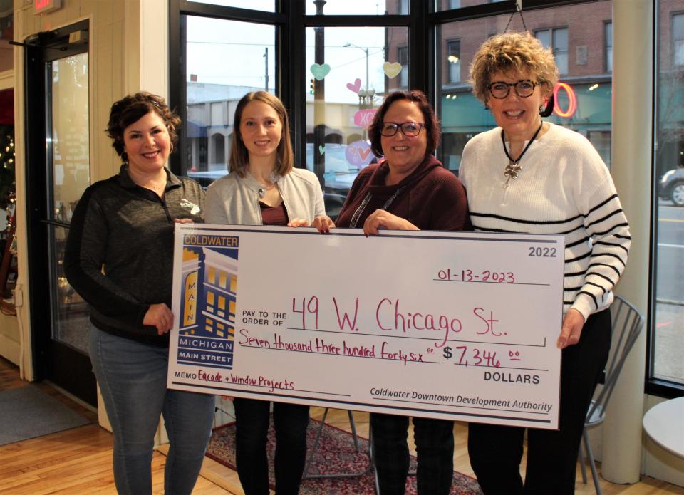Courtnay Dirschell and Audrey Tappenden from the DDA presented a $7,346 check to Kim Hemker and Diane Morrison of Hope Cafe for the replacement of windows and new outside lightening for 49 W. Chicago.