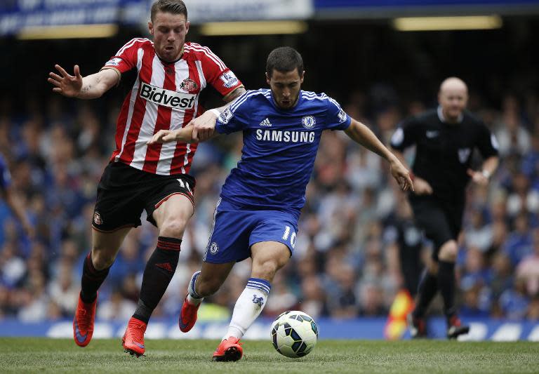 Sunderland's Connor Wickham (L) fights for the ball with Chelsea's Eden Hazard, English Premier League 'Player of the Season', during their match at Stamford Bridge in London, on May 24, 2015