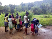 Children look to borrow books from a mobile library run on a motorbike by Mahinda Dasanayaka, in a village in Kegalle district, about 85 kilometers (53 miles) northeast of Sri Lanka's capital, Colombo, July 26, 20019. Having witnessed the hardships faced by children in rural areas whose villages have no library facilities, Dasanayaka got the idea for his library on wheels called “Book and Me." Dasanayaka, 32, works as a child protection officer for the government. On his off days, mostly during weekends, he rides his motorbike, which is fixed with a steel box to hold books, to rural villages and distributes the reading material to children free of charge. (AP Photo)