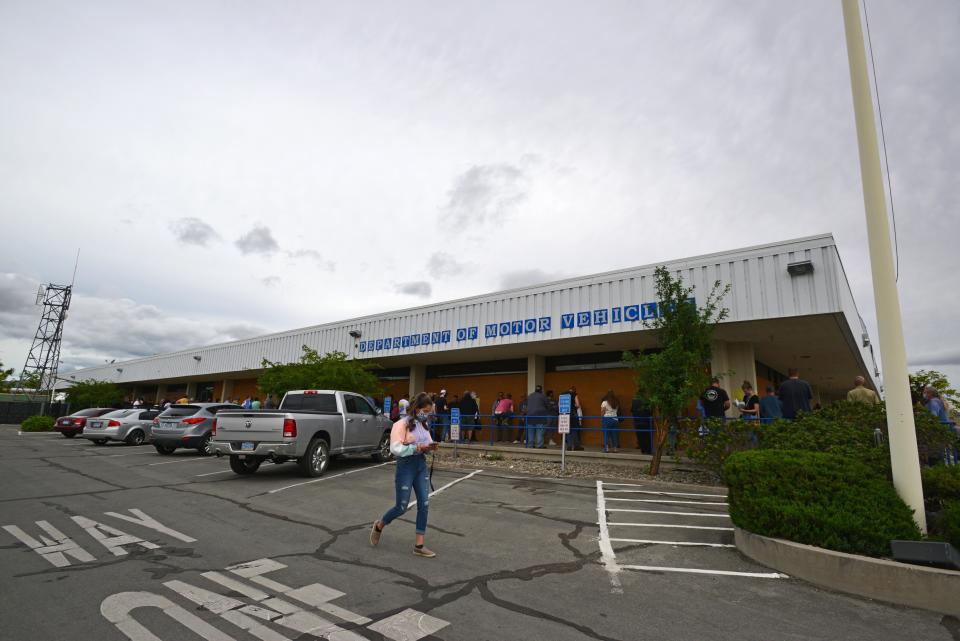 People stand in line to enter the Department of Motor Vehicles in Reno, Nev. The DMV temporarily suspended driving tests across the state because of concerns over spreading the novel coronavirus.