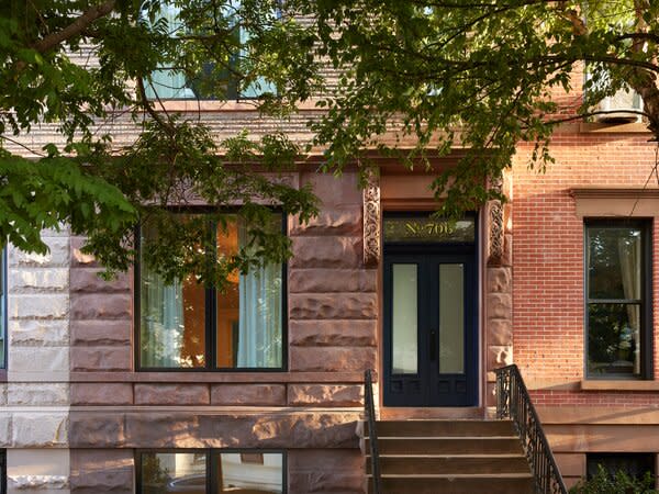 The front door is painted a blue color that’s repeated on the kitchen cabinets for 