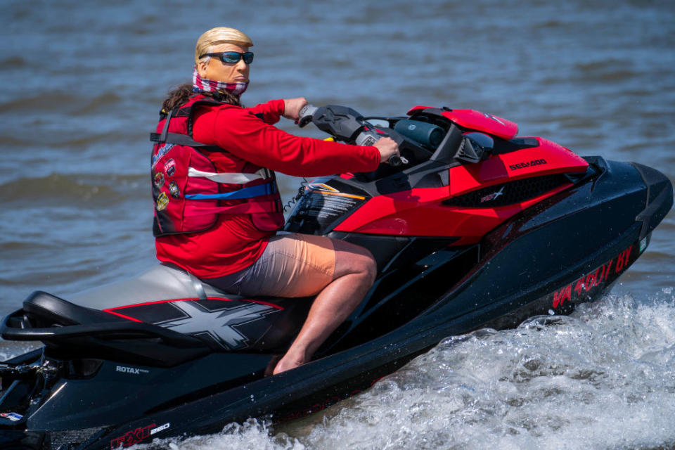 A person driving a power boat